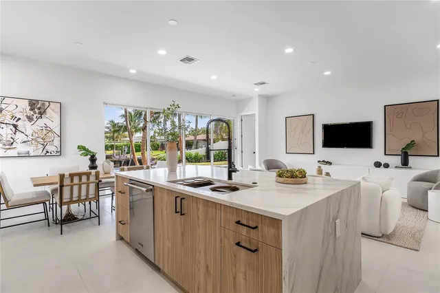 a kitchen with a sink and chairs