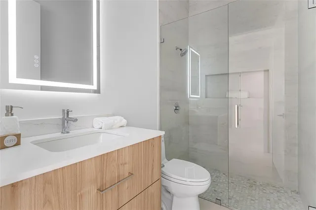 a bathroom with a sink toilet and shower