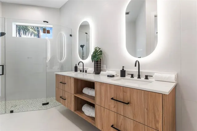a bathroom with double vanity sink and a mirror