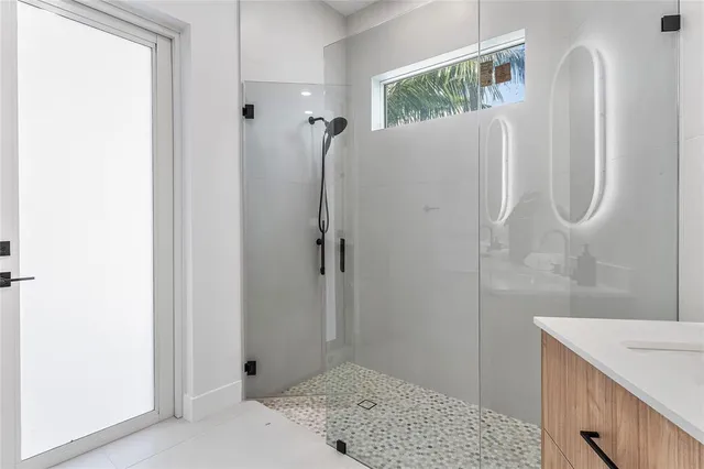 a bathroom with a shower and a sink
