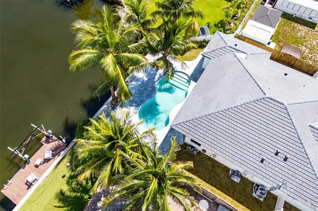 a view of a yard with plants and wooden fence