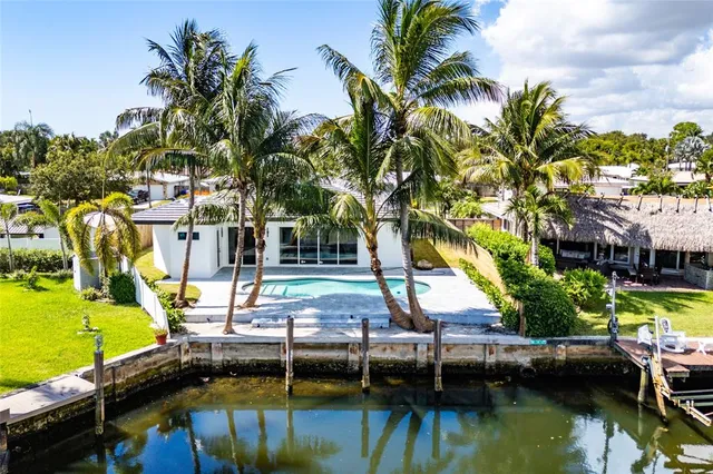 a view of house with swimming pool and lawn chairs