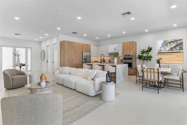 a living room with furniture kitchen and a table