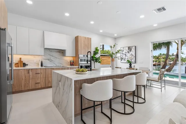 a kitchen with a sink cabinets and chairs