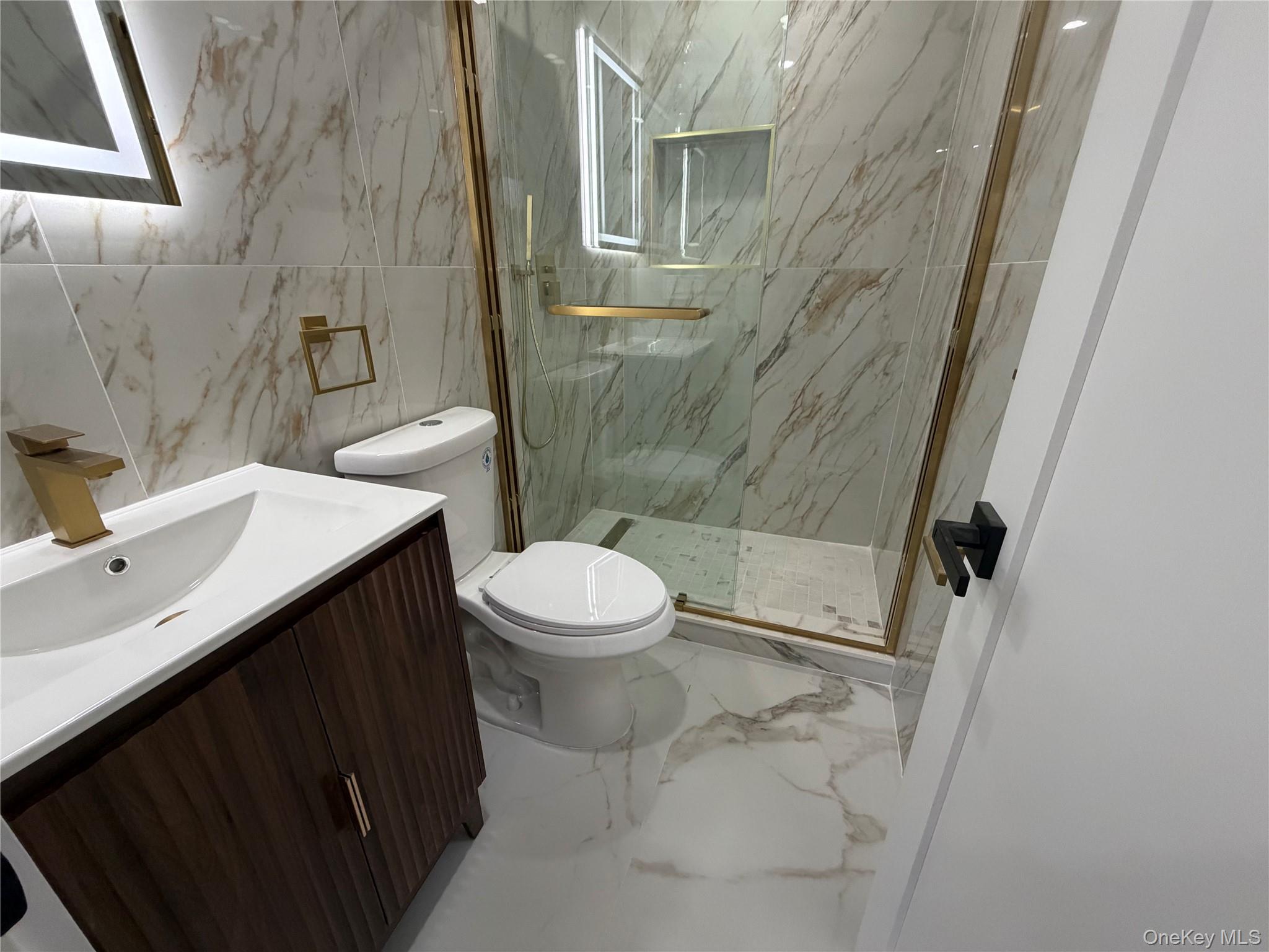 126-22 146th Street Queens, NY 11436 - Photo 12 of 20 a bathroom with a sink and mirror with toilet