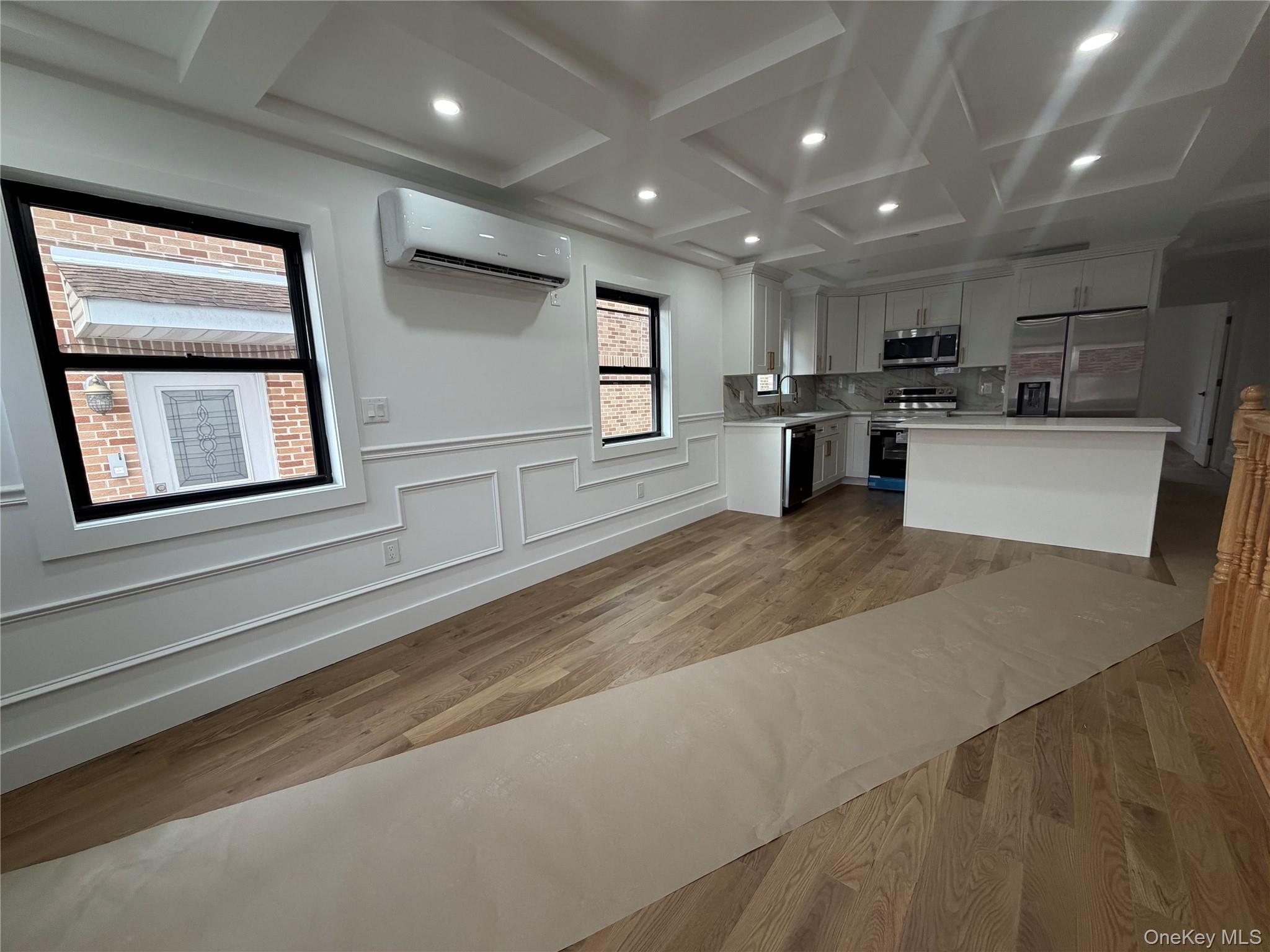 126-22 146th Street Queens, NY 11436 - Photo 3 of 20 a large kitchen with stainless steel appliances kitchen island a large counter top and a stove top oven