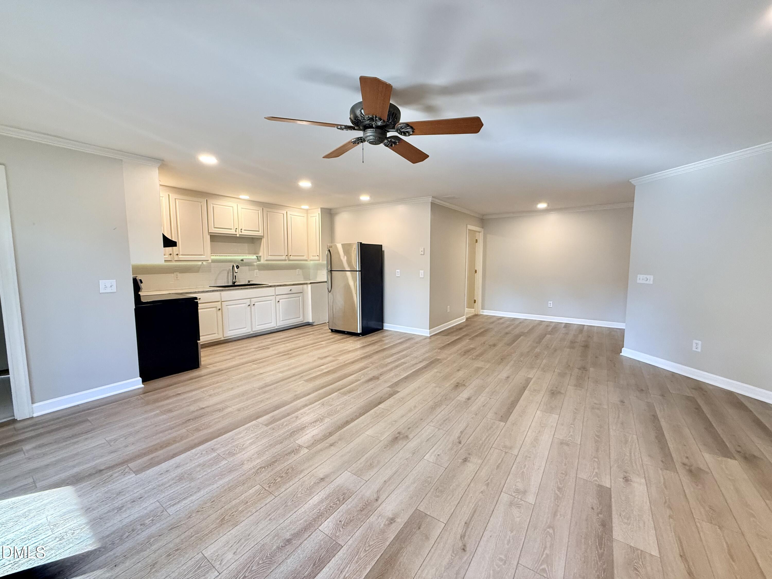 81 Beaver Crossing Road Roxboro, NC 27574 - Photo 47 of 80 a view of a kitchen with a sink and dishwasher a refrigerator with wooden floor