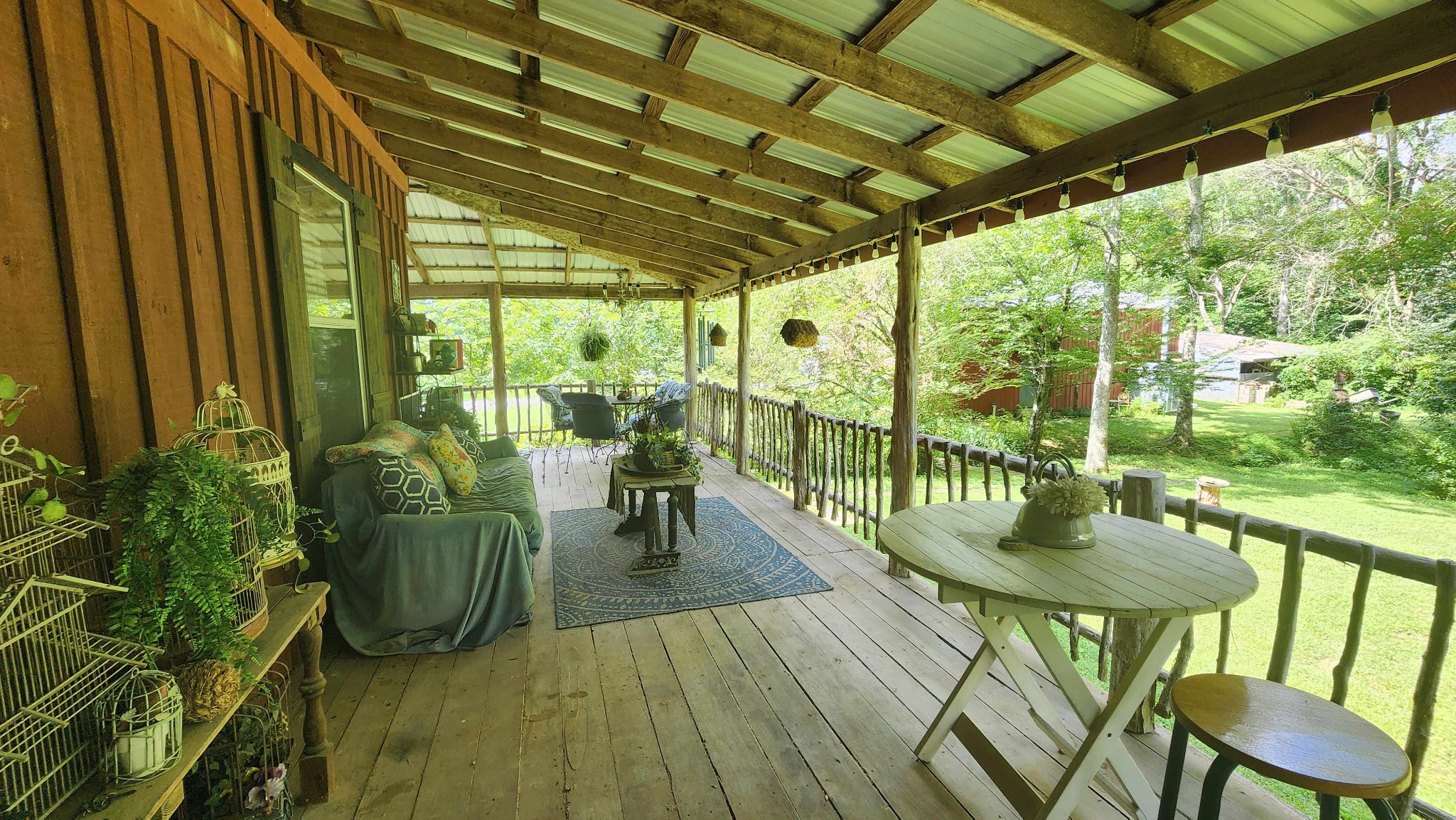 340 Christian Community Road Livingston, TN 38570 - Photo 43 of 79 a view of a patio with a table chairs and a backyard