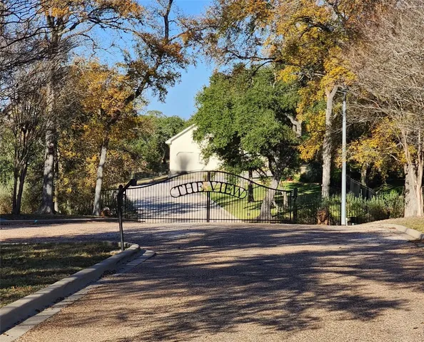 a view of a swimming pool with a lawn chairs under an umbrella