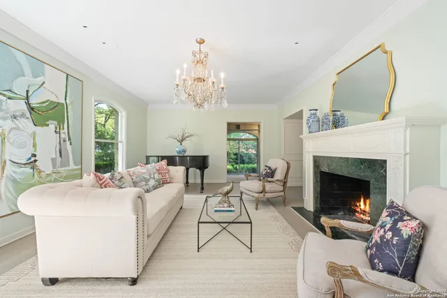 a living room with furniture and a chandelier