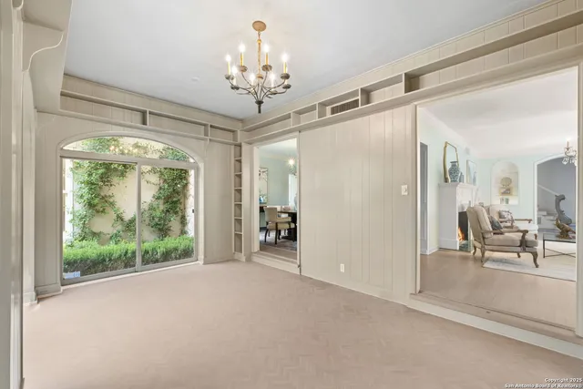 a living room with furniture and large windows