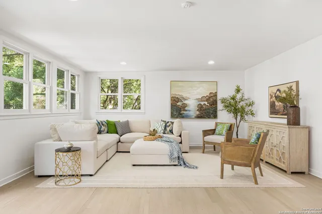 a kitchen with stainless steel appliances a dining table and chairs