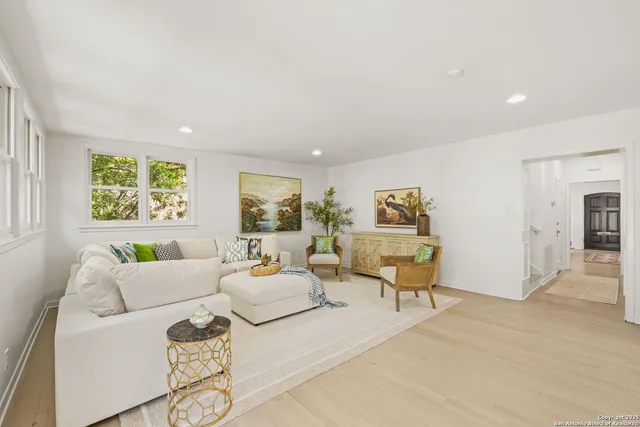 a view of a dining room with furniture a chandelier and wooden floor