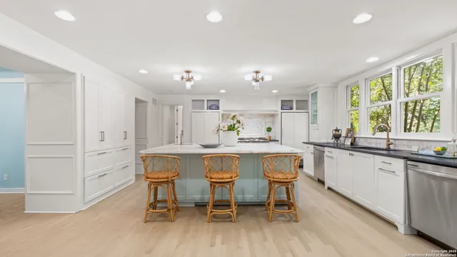 a kitchen with a sink and white cabinets