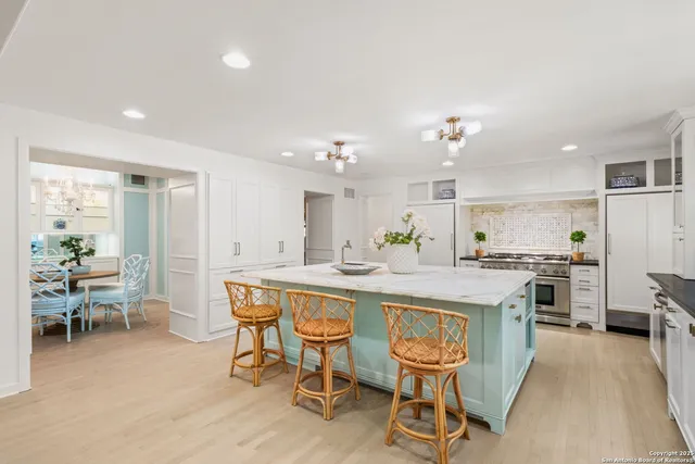 a stove top oven sitting inside of a kitchen