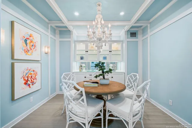 a spacious bedroom with a large bed and a chandelier