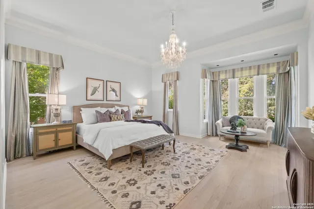 an empty room with windows and chandelier