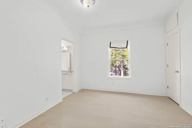 a front view of a house with garden and trees
