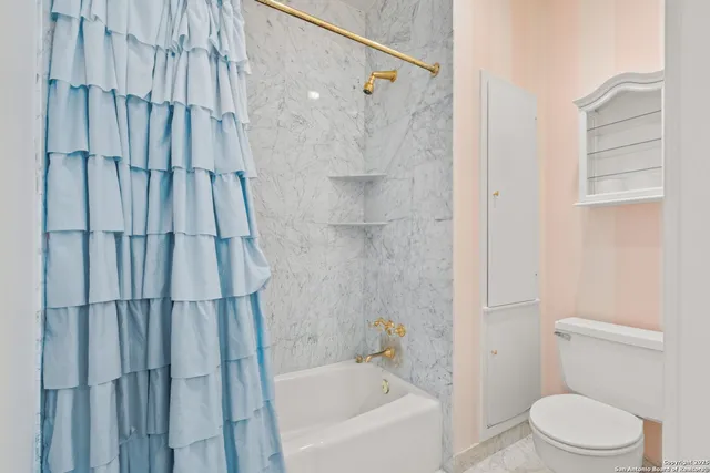 an aerial view of a house with a yard and lake view