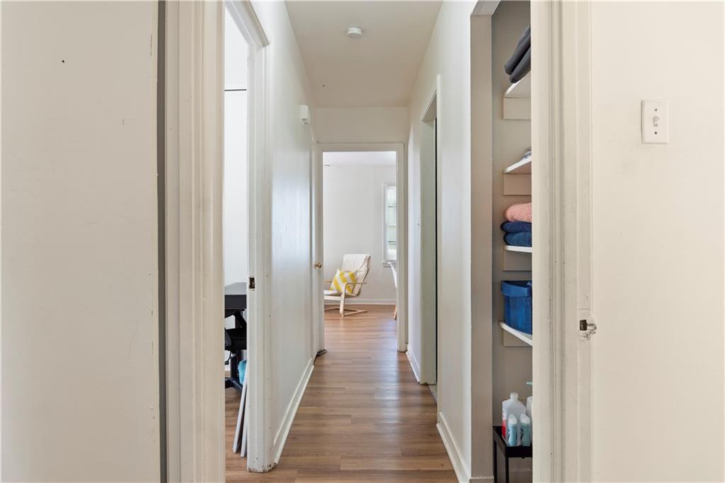 381 Lincoln Street Southwest Atlanta, GA 30315 - Photo 14 of 20 a view of a hallway with wooden floor and a bathroom