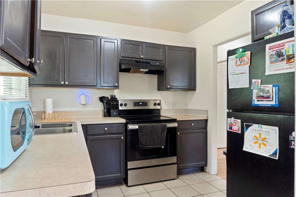 381 Lincoln Street Southwest Atlanta, GA 30315 - Photo 8 of 20 a kitchen with stainless steel appliances granite countertop a stove and a refrigerator