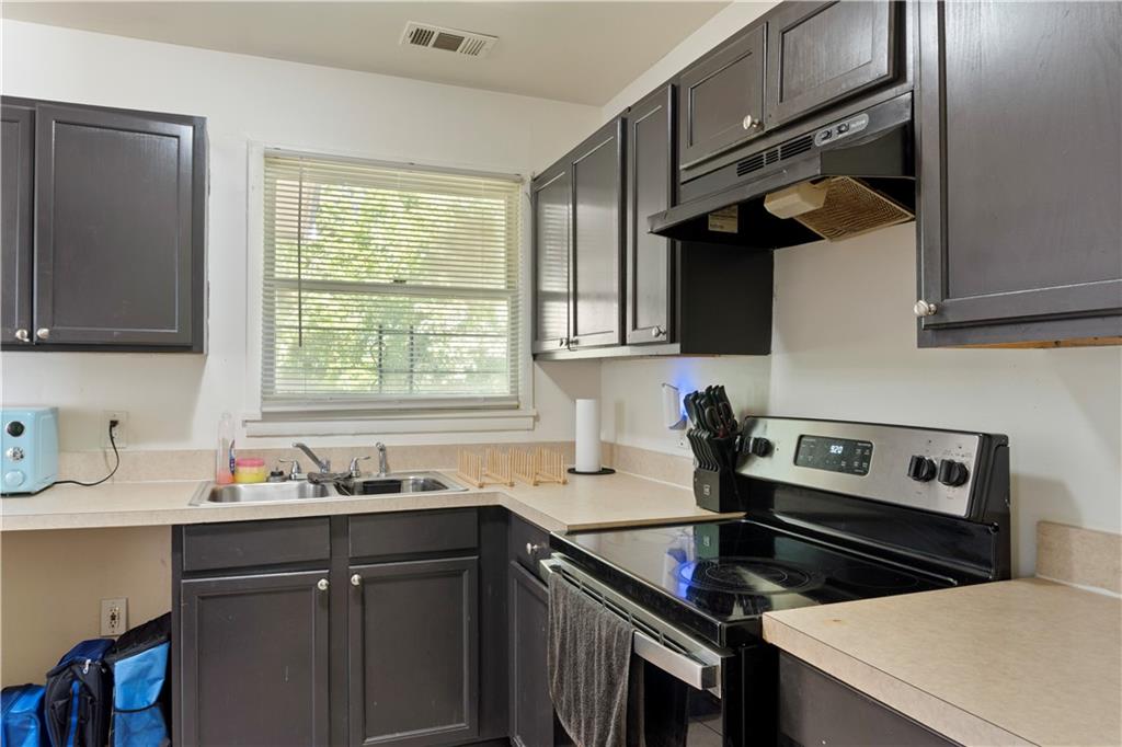 381 Lincoln Street Southwest Atlanta, GA 30315 - Photo 9 of 20 a kitchen with a sink stove top oven and cabinets