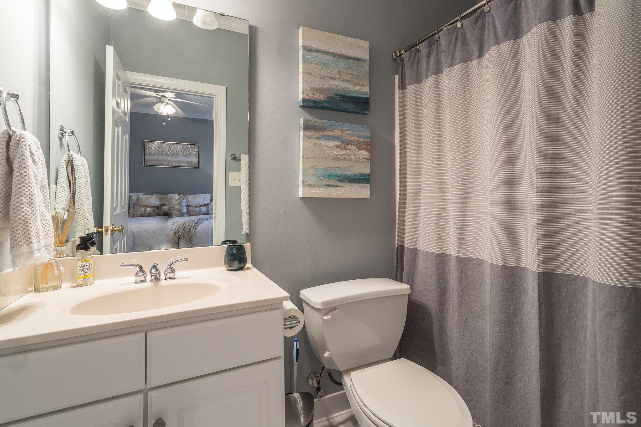 1311 Cameron View Court Raleigh, NC 27607 - Photo 29 of 33 a bathroom with a sink a toilet and shower curtain
