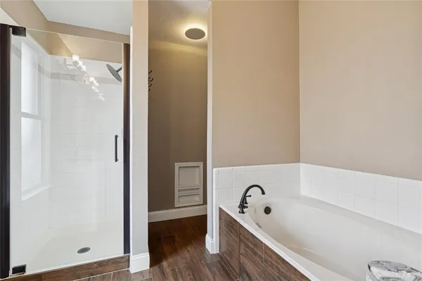 a bathroom with a tub and a shower