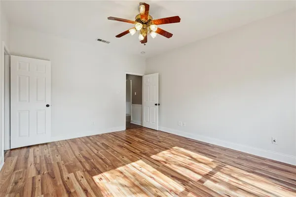 a view of a room with a ceiling fan and a window