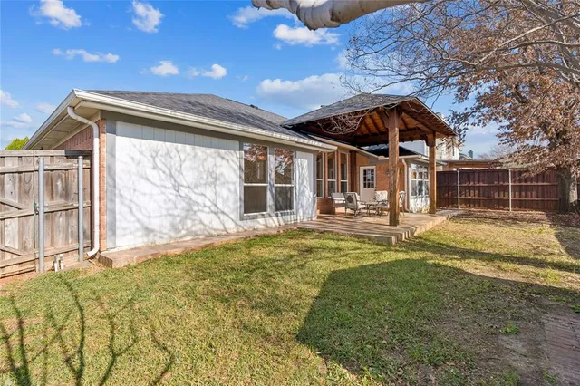 a swimming pool with outdoor seating and yard