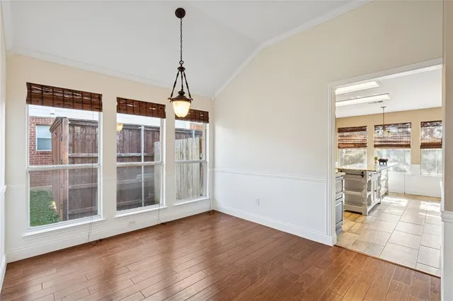 a view of a room with wooden floor and a window
