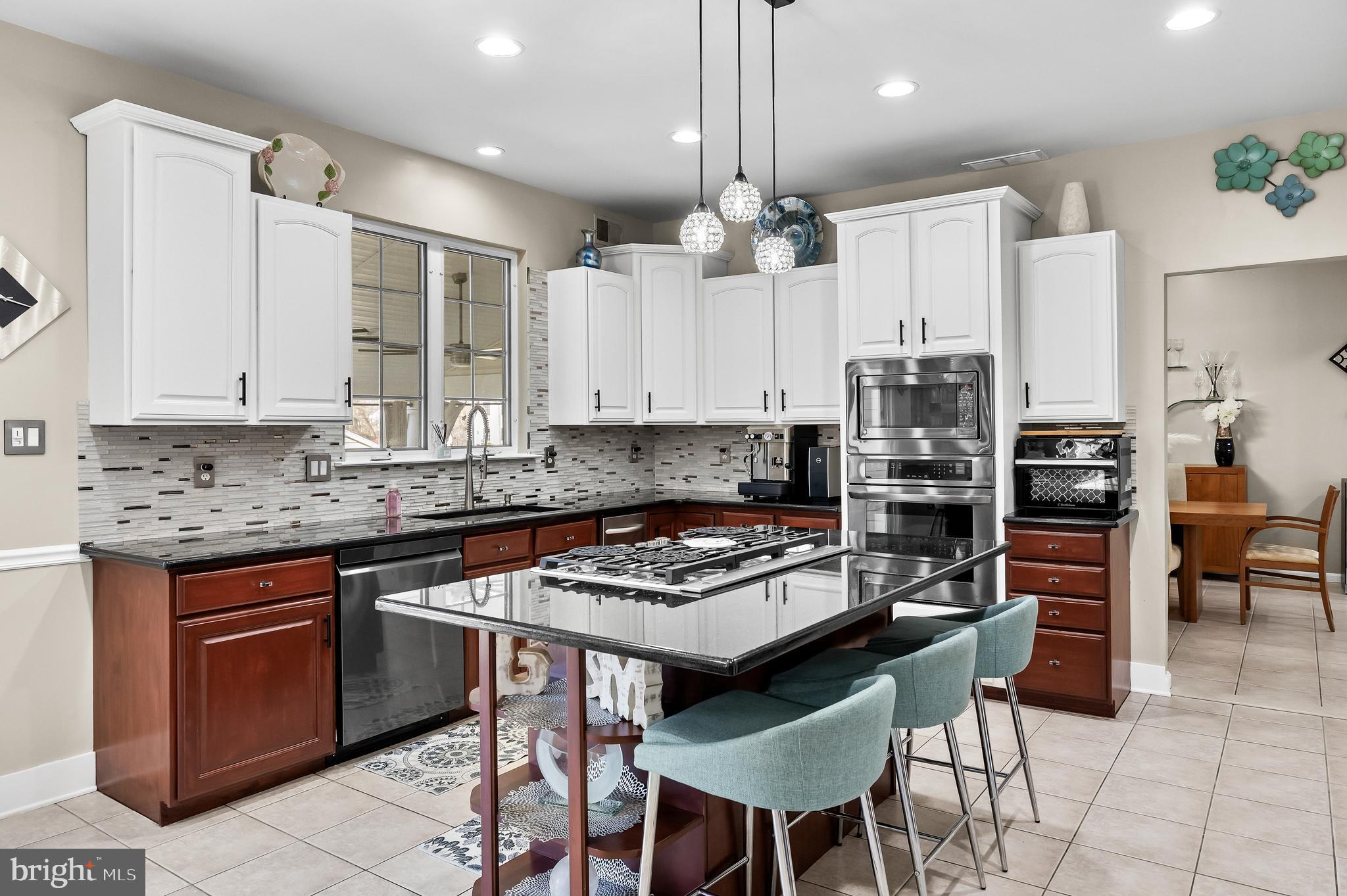 2 Rothbury Drive Lumberton, NJ 08048 - Photo 5 of 54 a kitchen with stainless steel appliances a stove a sink a table and chairs
