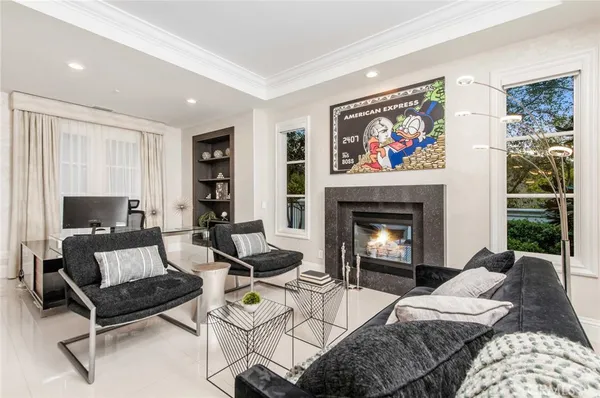 a living room with furniture a chandelier and wooden floor