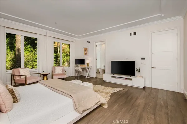 a bedroom with a bed and a large window