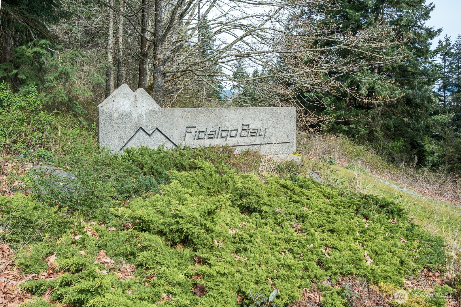 11711 Hummingbird Lane Anacortes, WA 98221 - Photo 13 of 14 a view of a sign in a garden