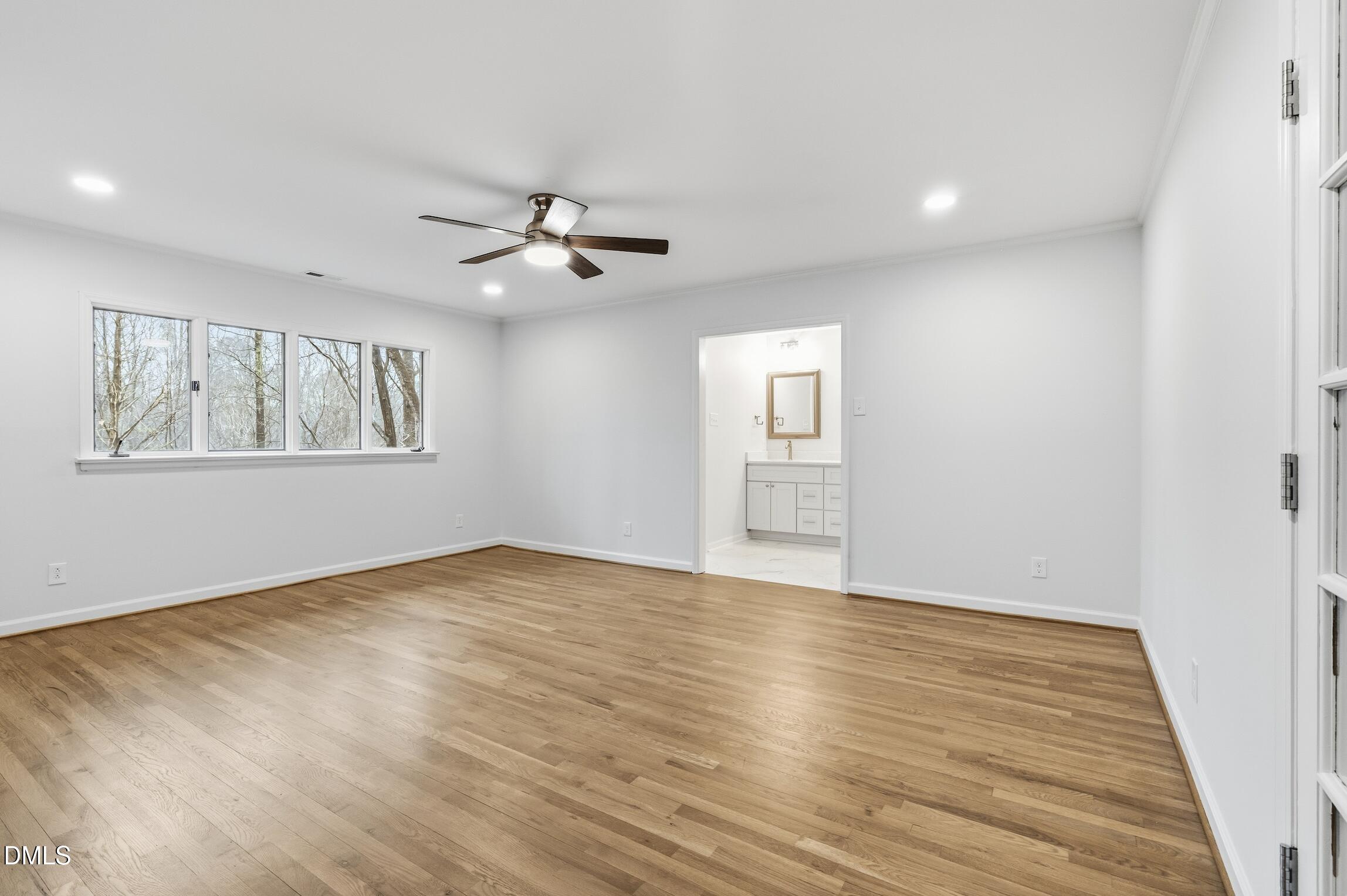 1504 Homestead Road Chapel Hill, NC 27516 - Photo 10 of 39 a view of an empty room with a window and wooden floor