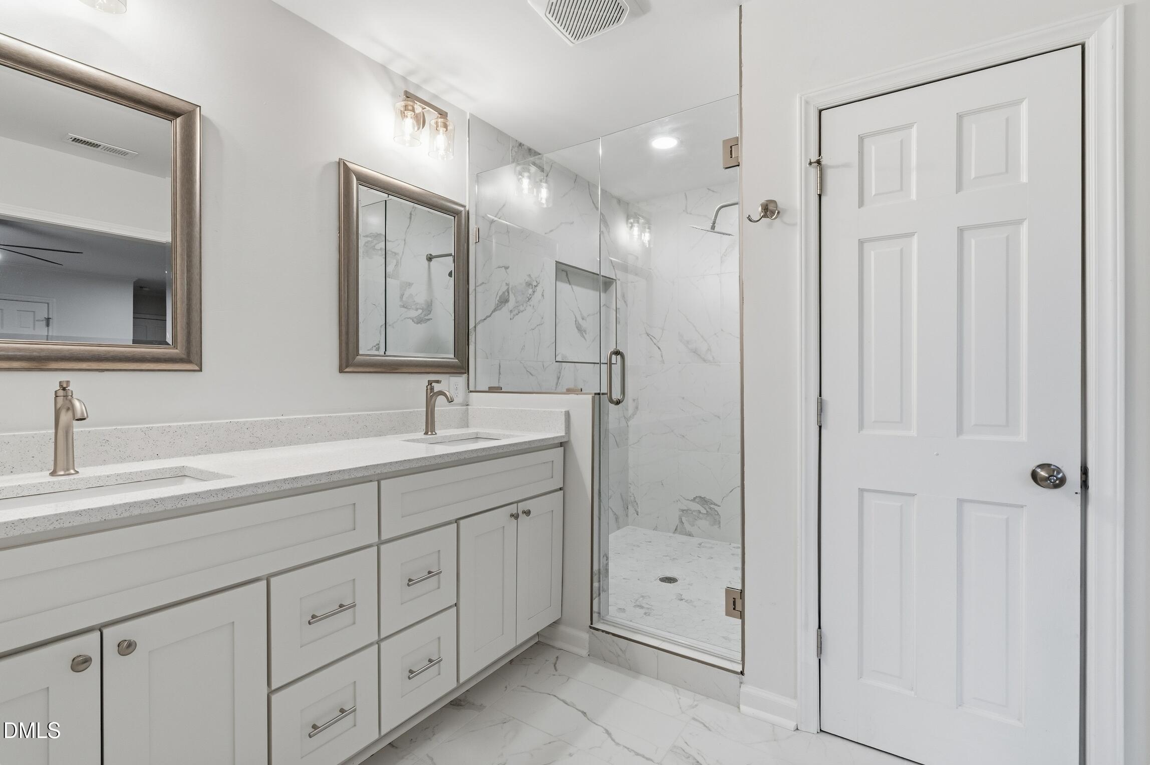 1504 Homestead Road Chapel Hill, NC 27516 - Photo 13 of 39 a spacious bathroom with double sink a mirror a shower and a bathtub