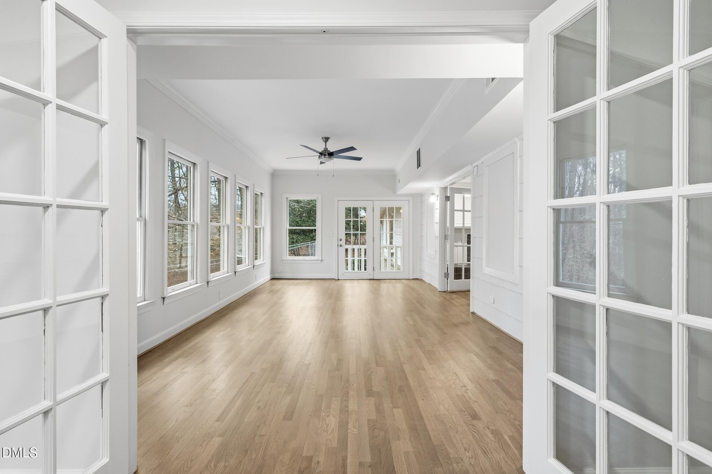 1504 Homestead Road Chapel Hill, NC 27516 - Photo 15 of 39 a view of an empty room with wooden floor and windows