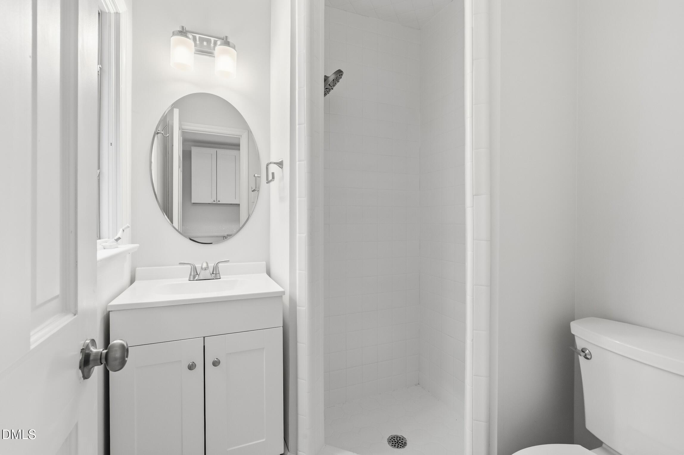 1504 Homestead Road Chapel Hill, NC 27516 - Photo 20 of 39 a bathroom with a granite countertop toilet a sink and mirror