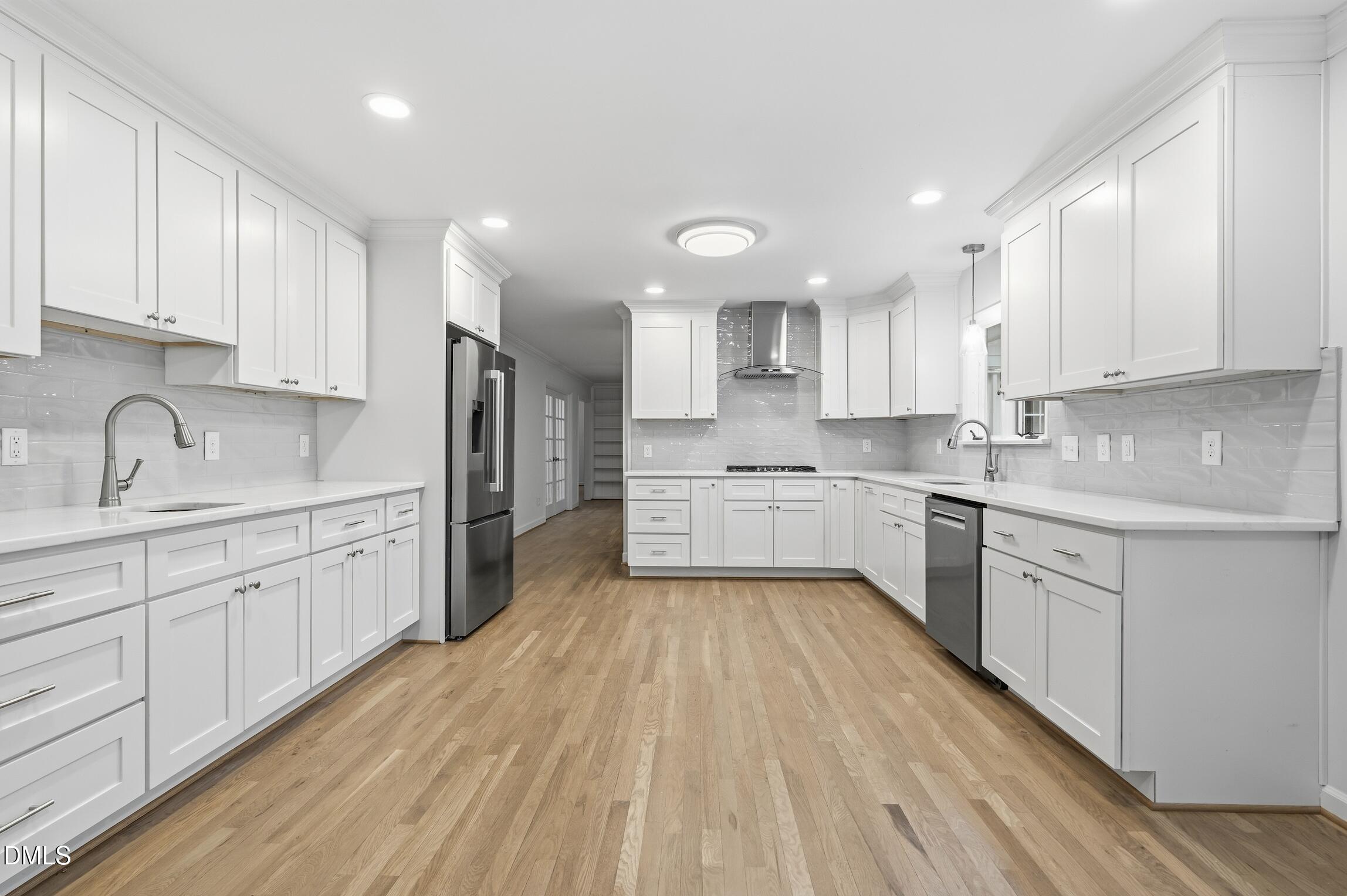 1504 Homestead Road Chapel Hill, NC 27516 - Photo 23 of 39 a large kitchen with cabinets stainless steel appliances a sink and a center island