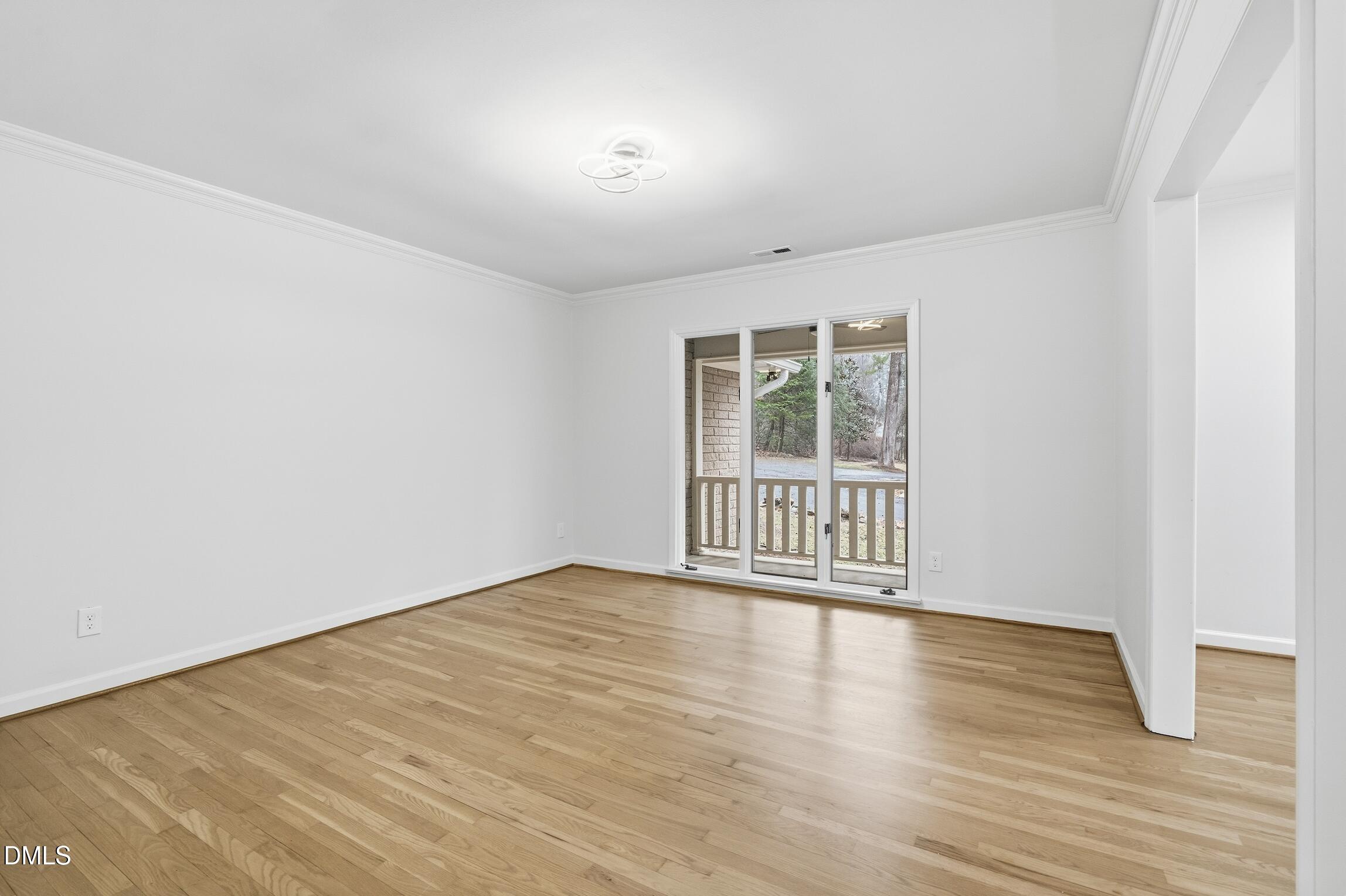 1504 Homestead Road Chapel Hill, NC 27516 - Photo 25 of 39 a view of an empty room with wooden floor and a window