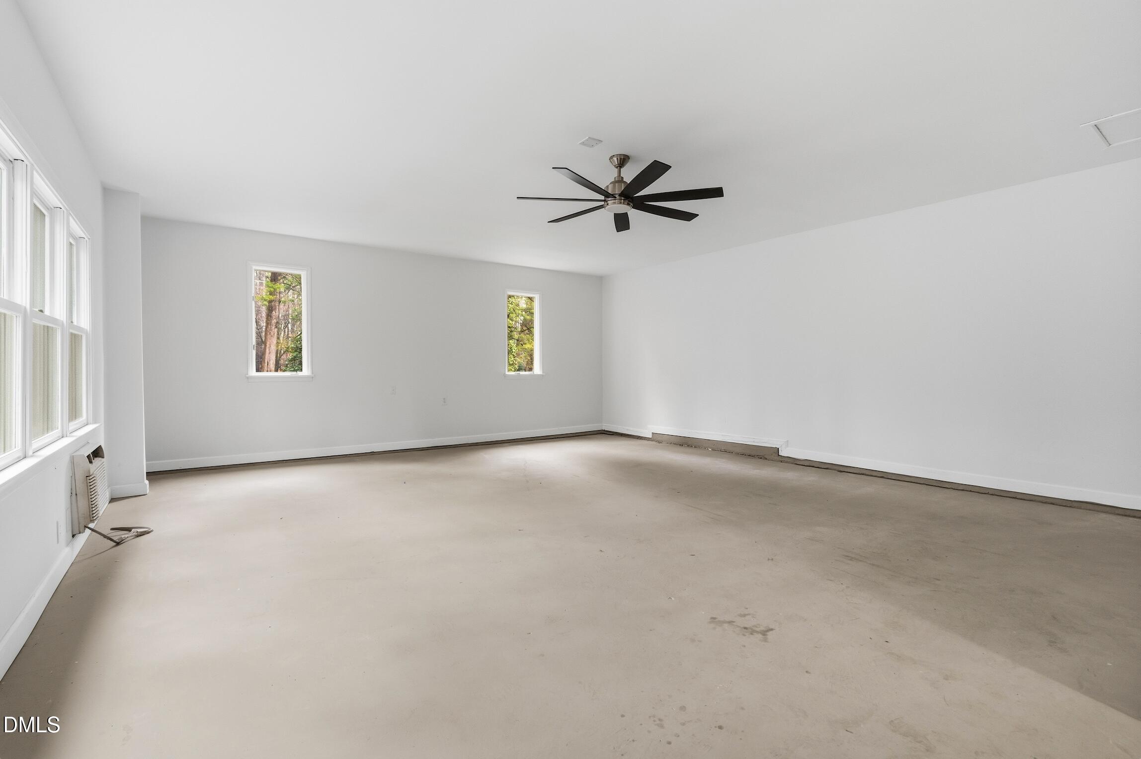 1504 Homestead Road Chapel Hill, NC 27516 - Photo 28 of 39 an empty room with windows and fan