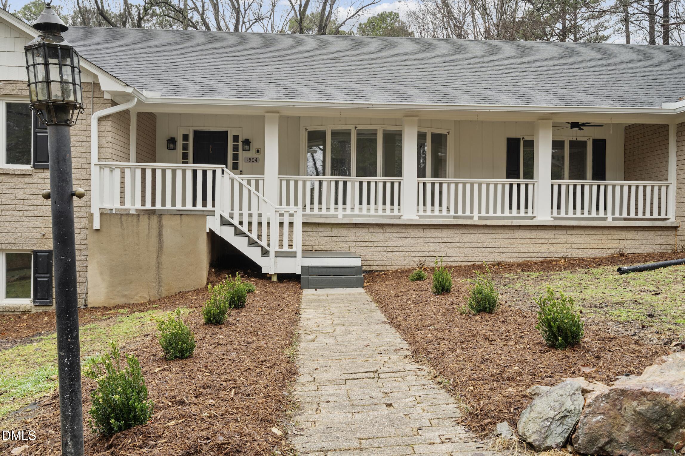 1504 Homestead Road Chapel Hill, NC 27516 - Photo 2 of 39 a front view of a house with a yard