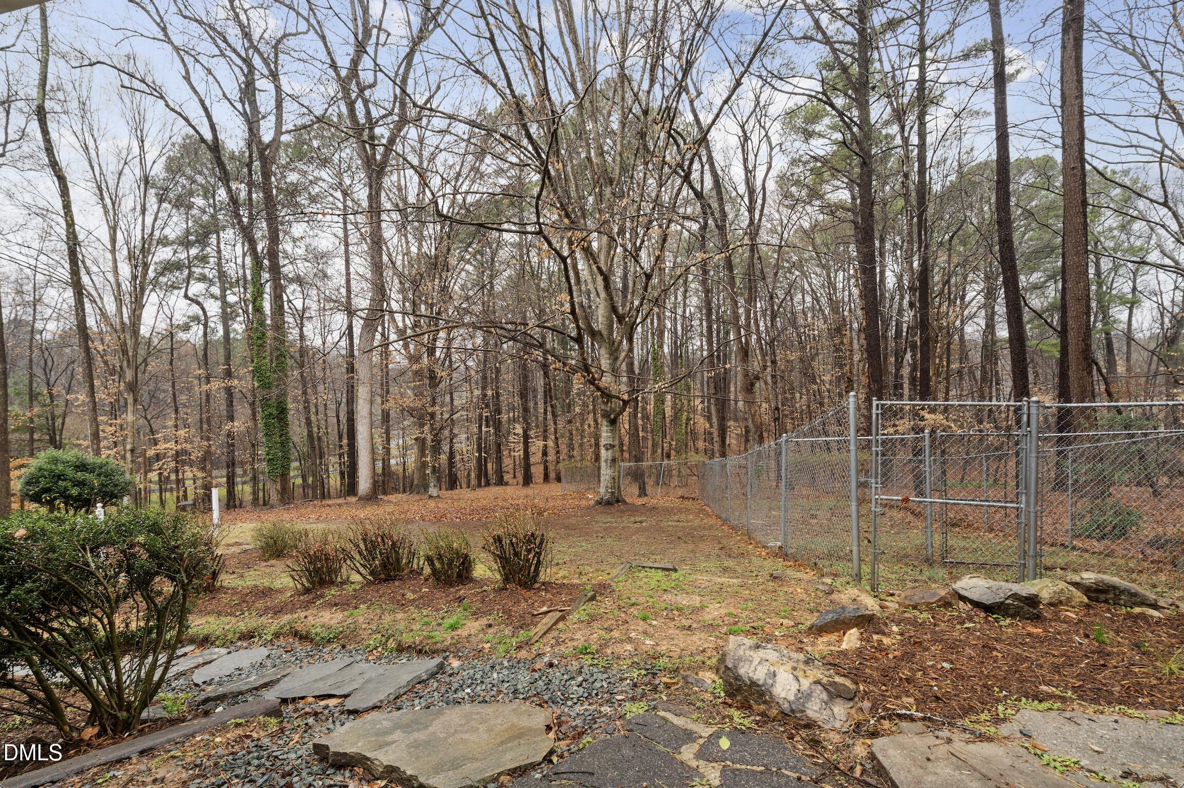 1504 Homestead Road Chapel Hill, NC 27516 - Photo 30 of 39 a backyard of a house with trees and houses