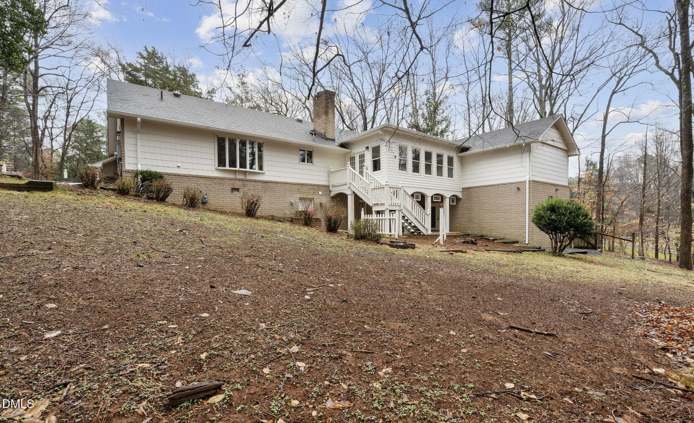 1504 Homestead Road Chapel Hill, NC 27516 - Photo 34 of 39 a front view of a house with a yard and garage