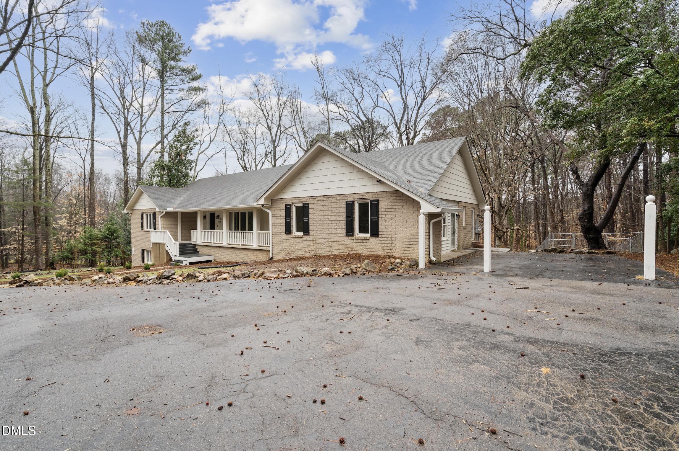 1504 Homestead Road Chapel Hill, NC 27516 - Photo 36 of 39 a white house with a large tree in front of it