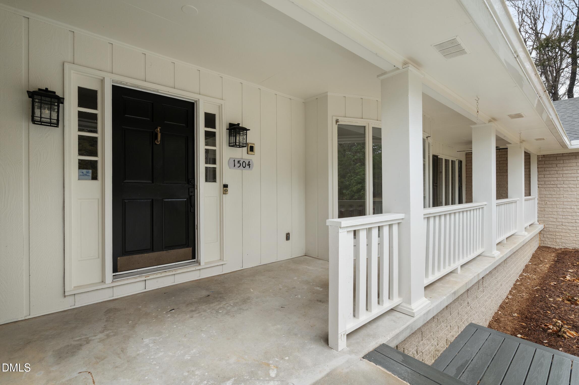 1504 Homestead Road Chapel Hill, NC 27516 - Photo 3 of 39 a view of a porch with wooden floor and fence