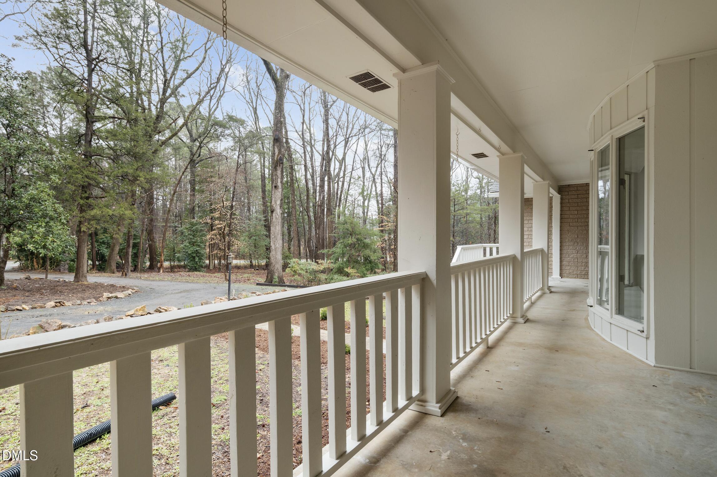 1504 Homestead Road Chapel Hill, NC 27516 - Photo 4 of 39 a view of a balcony with wooden floor and fence