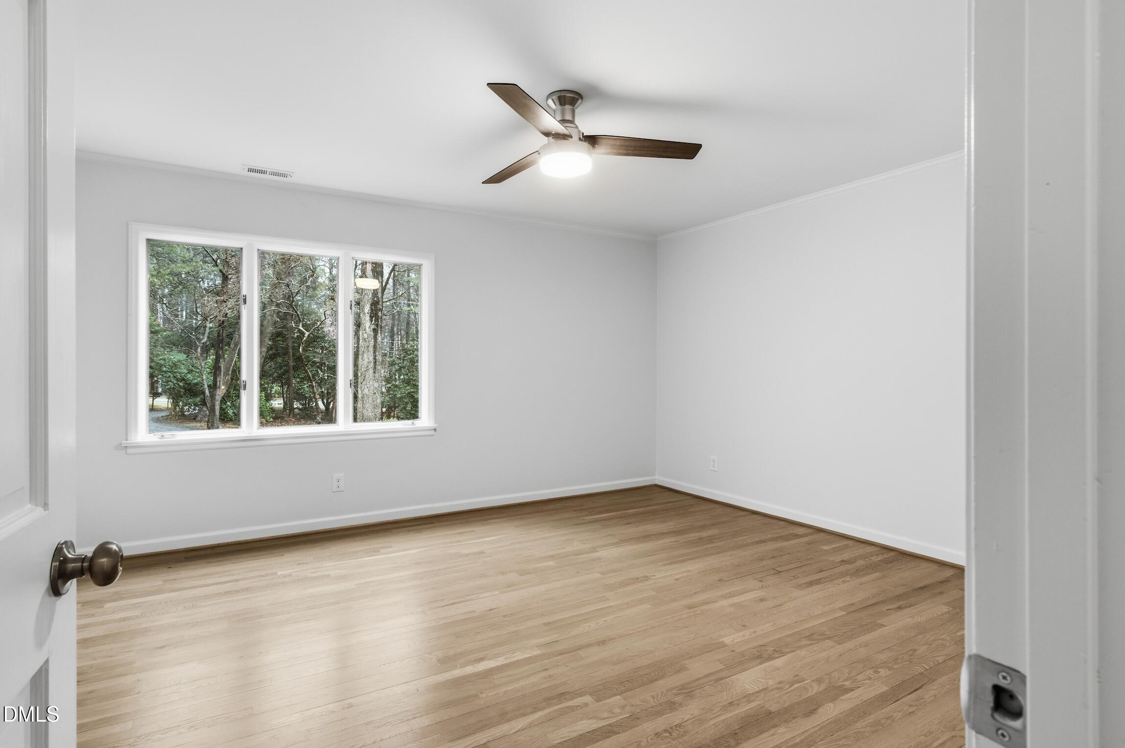 1504 Homestead Road Chapel Hill, NC 27516 - Photo 7 of 39 an empty room with a ceiling fan and window