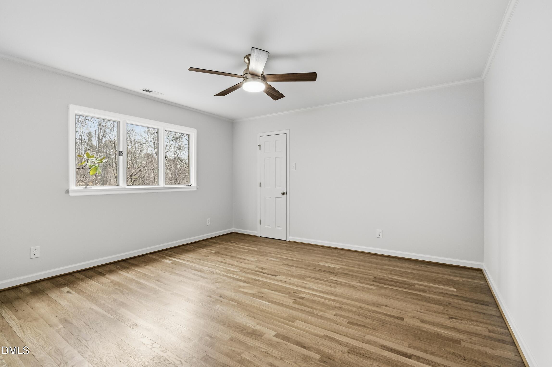 1504 Homestead Road Chapel Hill, NC 27516 - Photo 9 of 39 a view of an empty room with wooden floor and a window